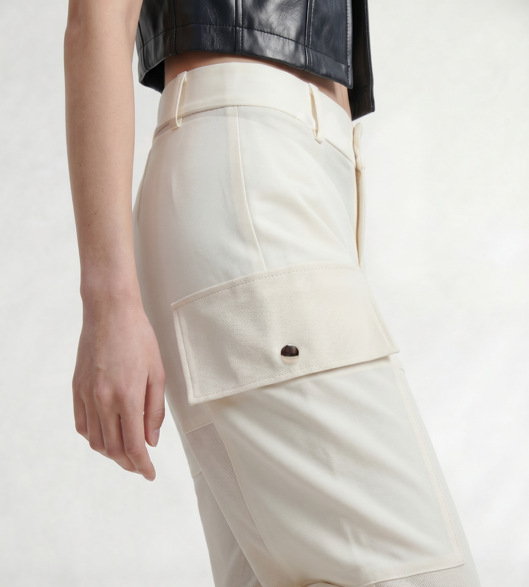 Close-up of IL CARGO TRASPARENTE by ORNELLA COLICCHIO highlighting the contrast between Italian wool fabric, transparent technical fabric and structured cargo pockets