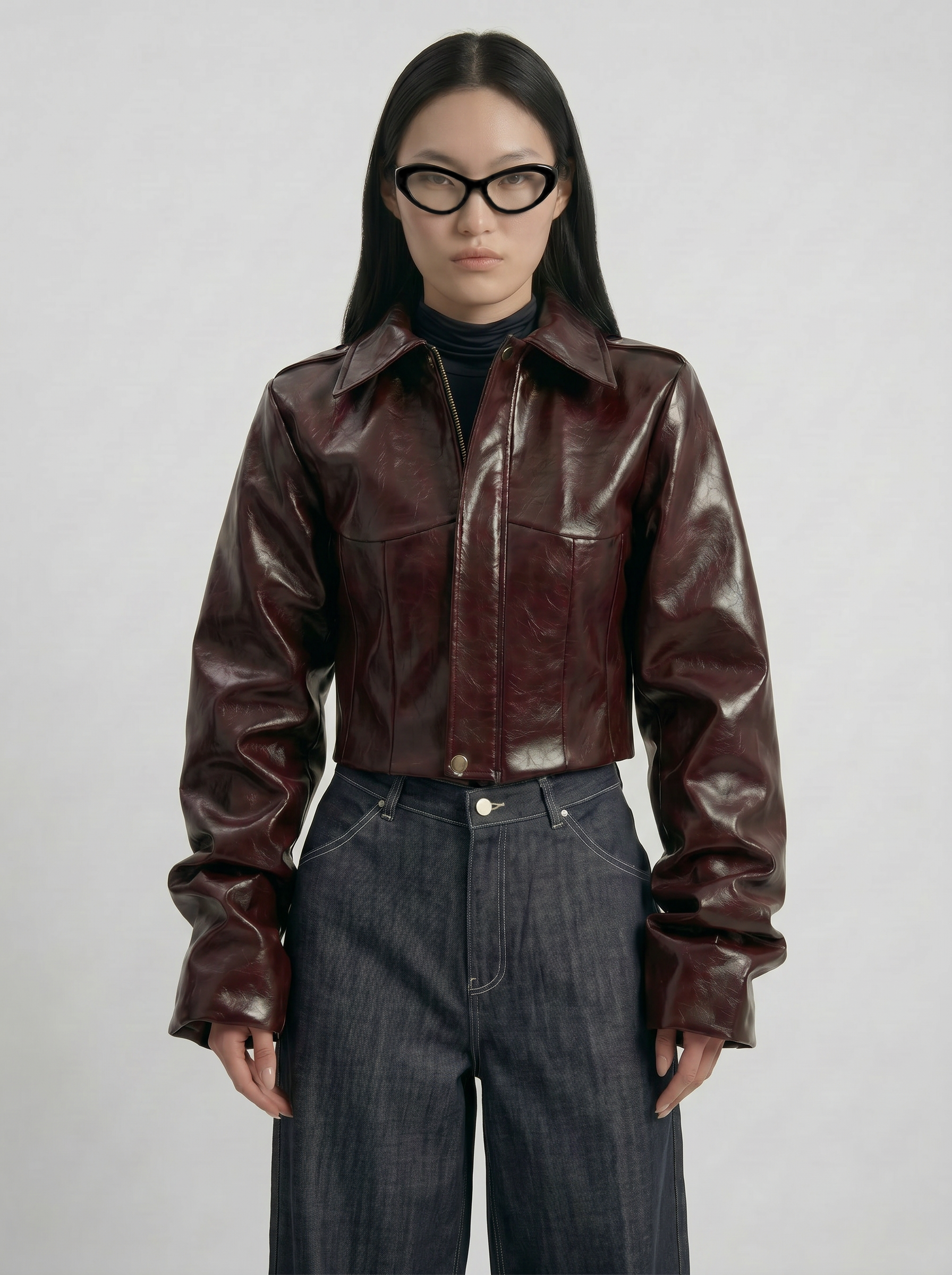 Front view of model wearing LA GIACCA CORTA BORDEAUX by ORNELLA COLICCHIO with sculptural sleeves and cropped hip-length silhouette, styled with IL DENIM TRIANGOLO