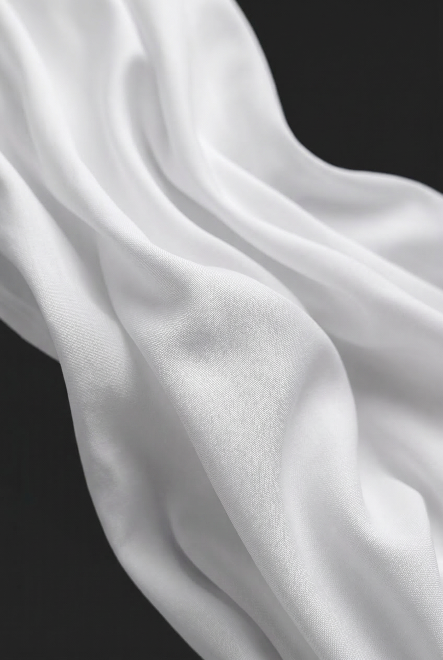 Close-up of LA CAMICIA OTTANTA by ORNELLA COLICCHIO showing the smooth white cotton fabric against a black background