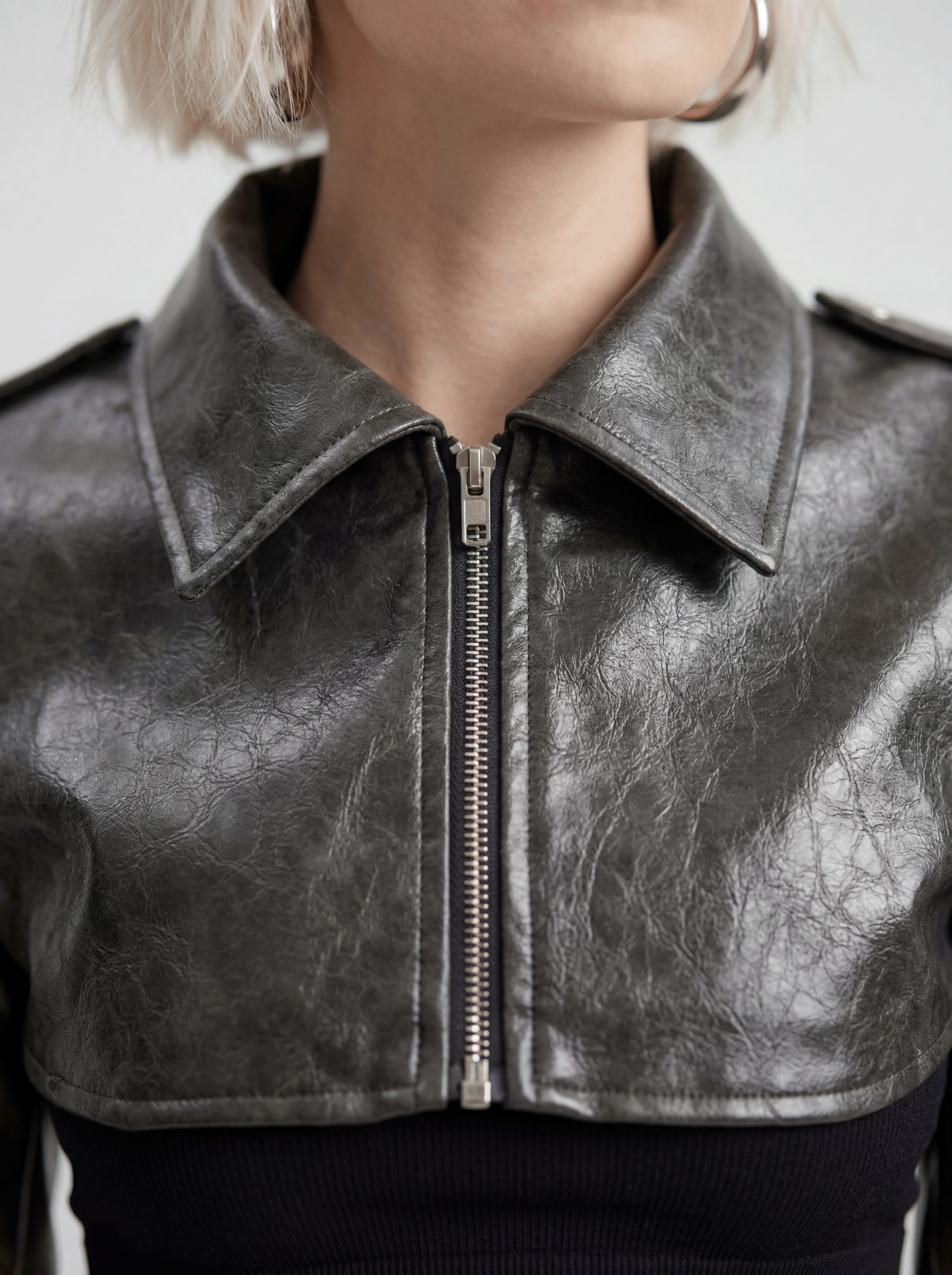 Close front view of model wearing LA GIACCA CORTA SCULTURA by ORNELLA COLICCHIO, highlighting the collar, stitching and zipper