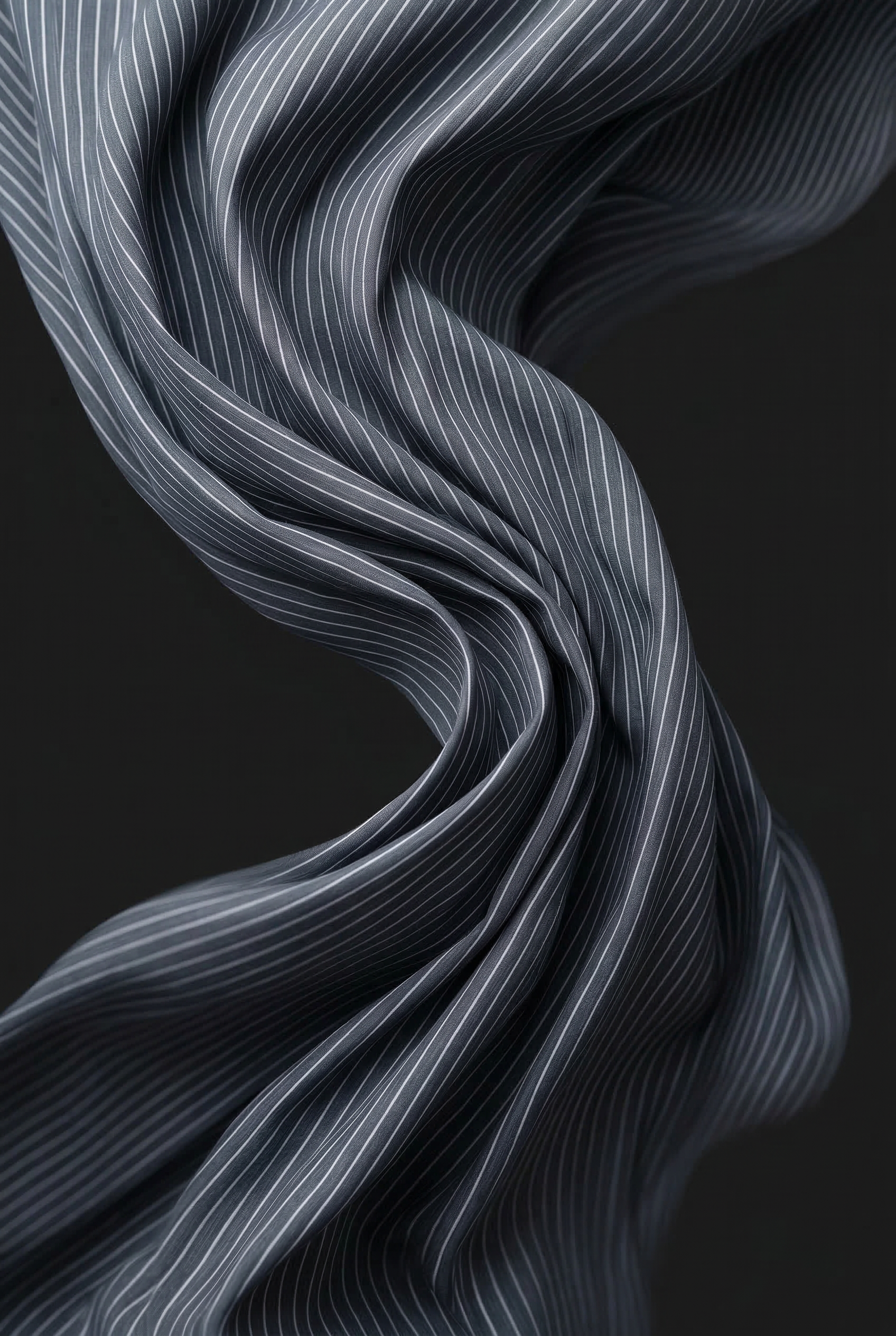 Close-up of L’ABITO CAMICIA SPALLE SCOLPITE by ORNELLA COLICCHIO showing blue and white striped cotton fabric against a black background