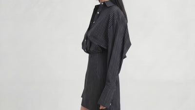 Video of model wearing L’ABITO CAMICIA SPALLE SCOLPITE by ORNELLA COLICCHIO, turning from side view to front view to show the tailored collar, buttons and backward-falling shirt construction