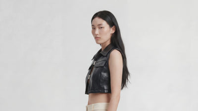 Video of model wearing TOP OCEANO CON FIBBIE by ORNELLA COLICCHIO, starting in side view and turning left to reveal the back of the ocean blue top
