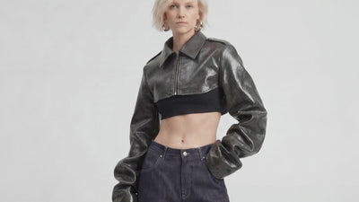 Video of model wearing LA GIACCA CORTA SCULTURA by ORNELLA COLICCHIO, posing from right to left to highlight the sculptural sleeves, styled with IL DENIM TRIANGOLO