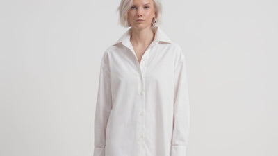 Video of model wearing LA CAMICIA OTTANTA by ORNELLA COLICCHIO, walking toward the camera to show the front view, long silhouette and wide collar