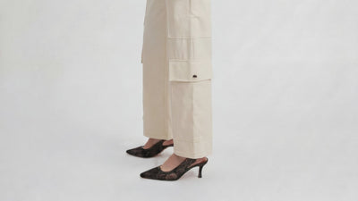 Video of IL CARGO TRASPARENTE by ORNELLA COLICCHIO, with the camera moving from the shoes up the side of the trousers to highlight the large cargo pockets